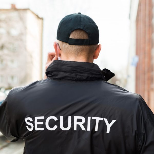 Close-up Of Male Security Guard Wearing Black Jacket